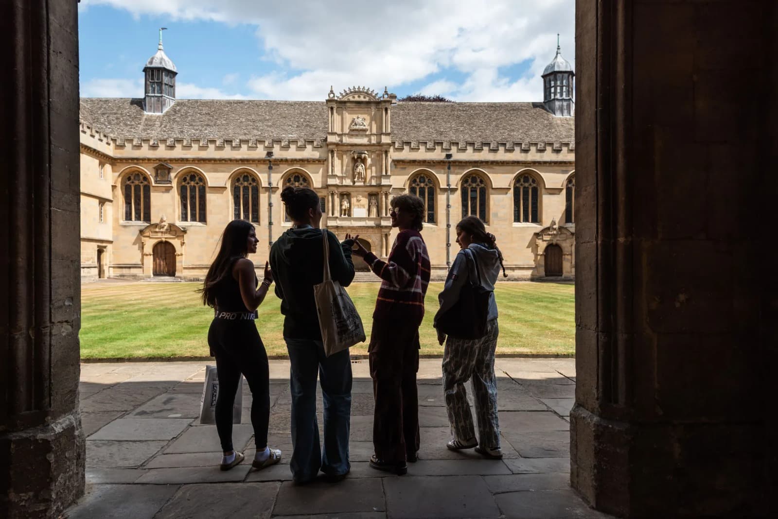 Students standing in the doorway of a historic college quad