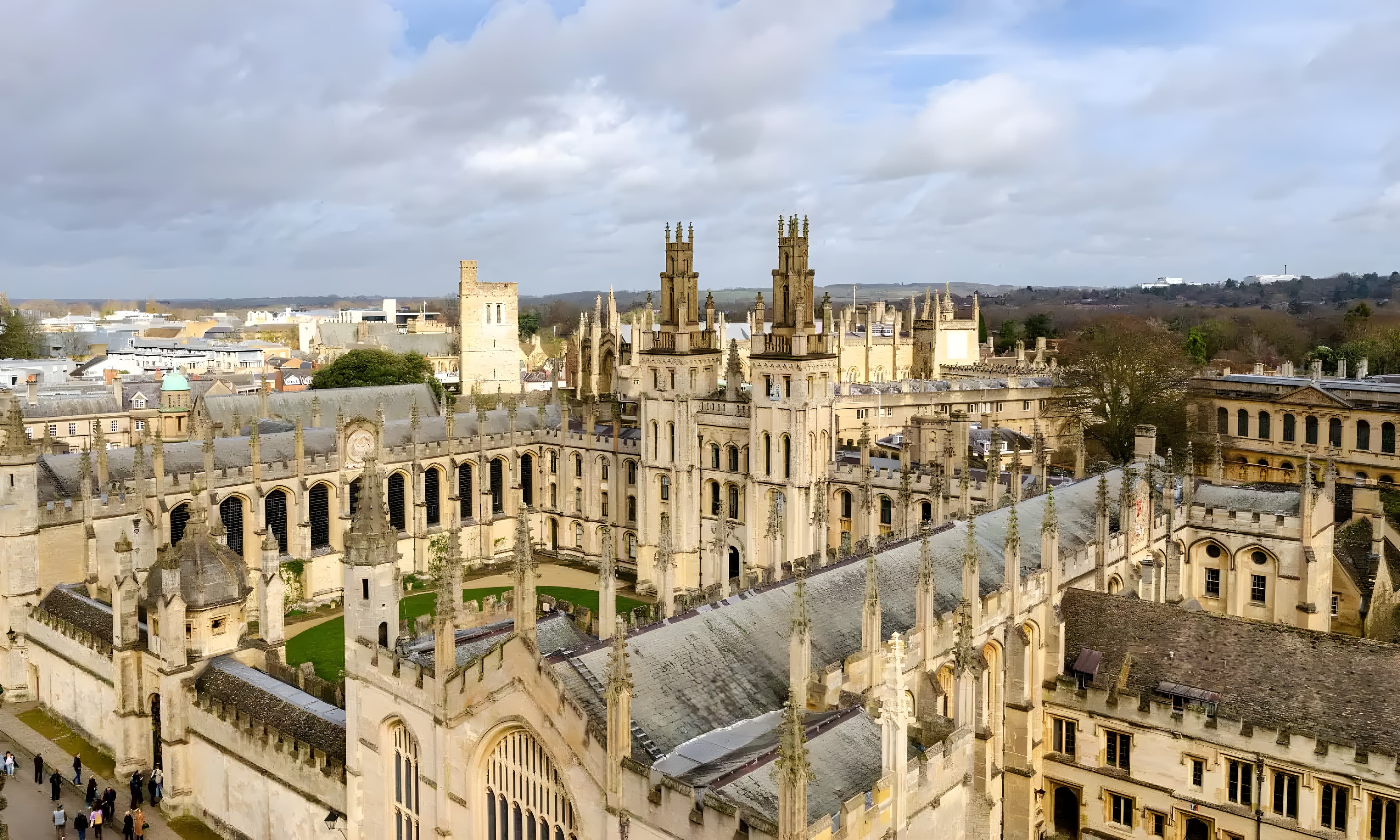 A college quad with a manicured lawn and historic buildings