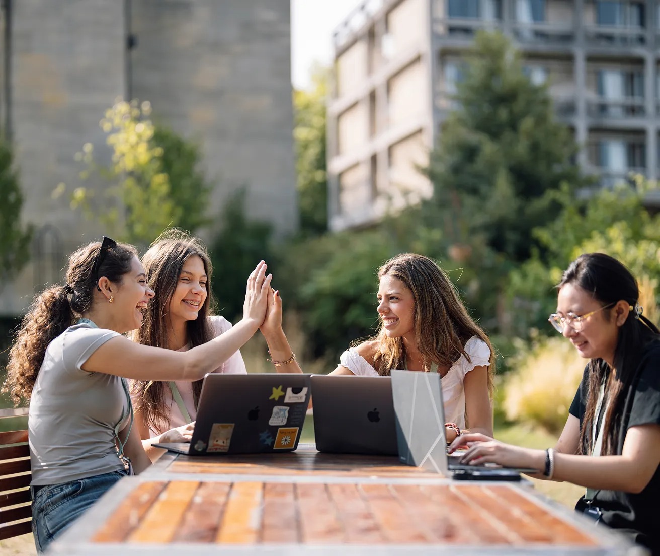 Students talking together at a table outdoors