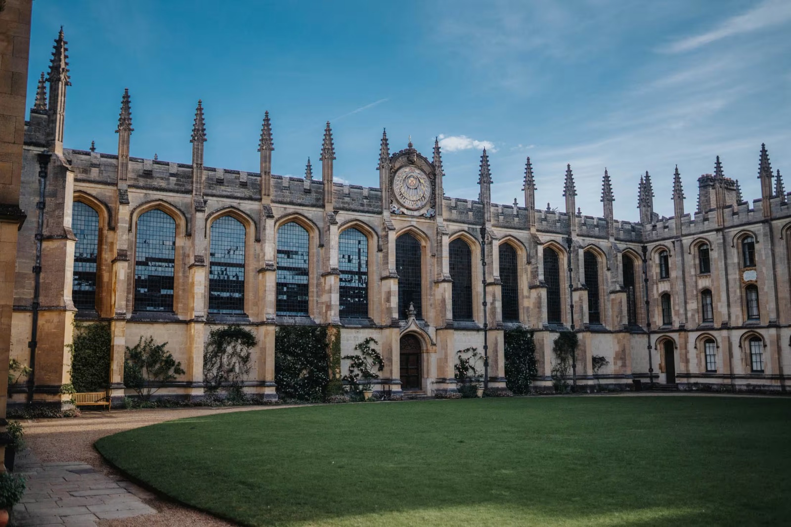 A historic college building with a manicured lawn